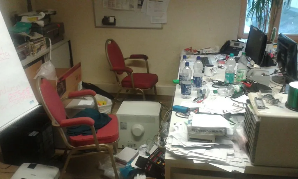 Cluttered office workspace during my years managing hotel IT systems